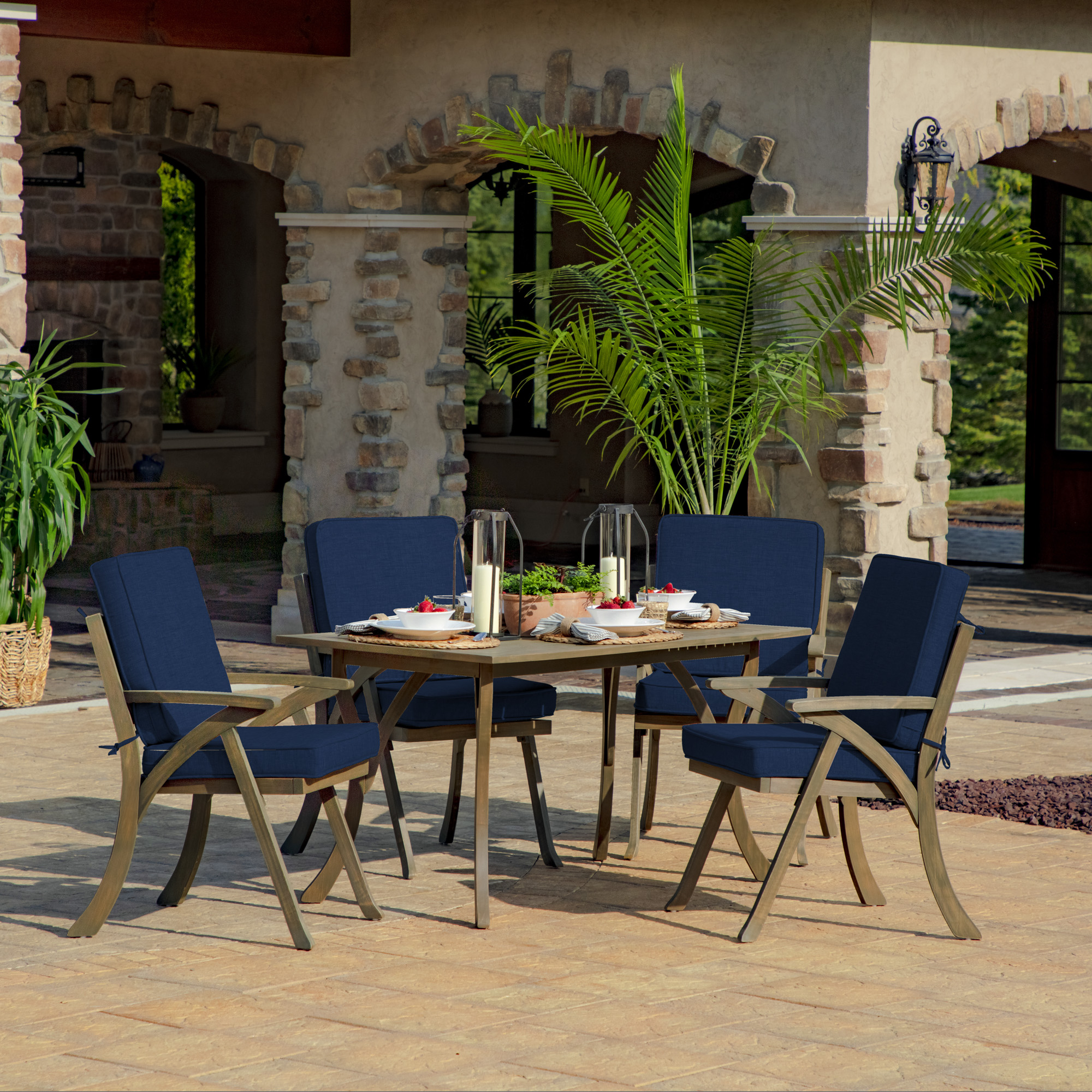 blue outdoor dining chairs around table
